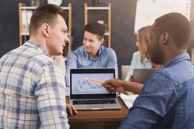 business-team-talking-about-results-their-work-group-cheerful-businesspeople-studying-chart-laptop-discussing-new-marketing-strategy-sitting-office-copy-space_116547-8502